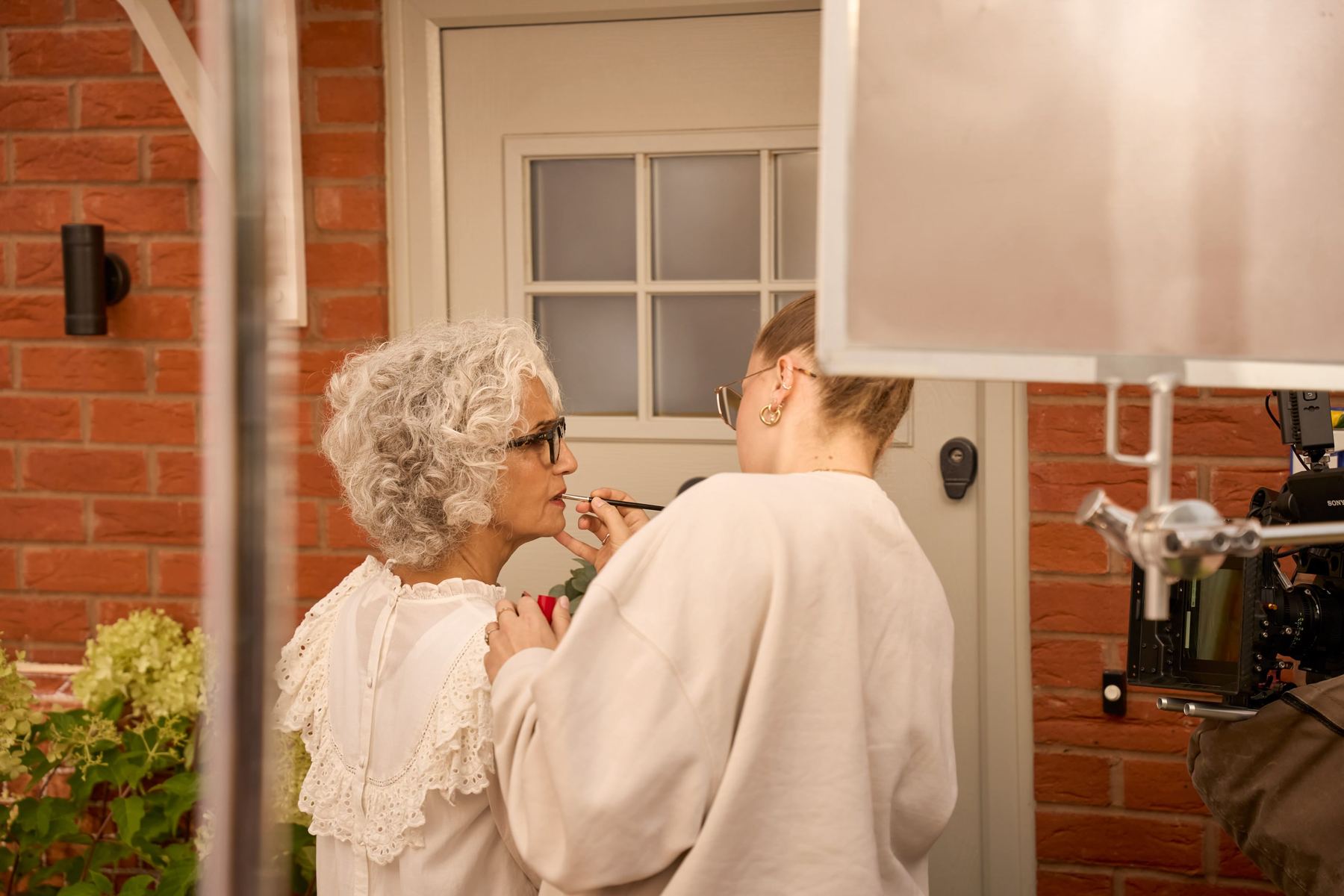 Hair and makeup touch-up between takes