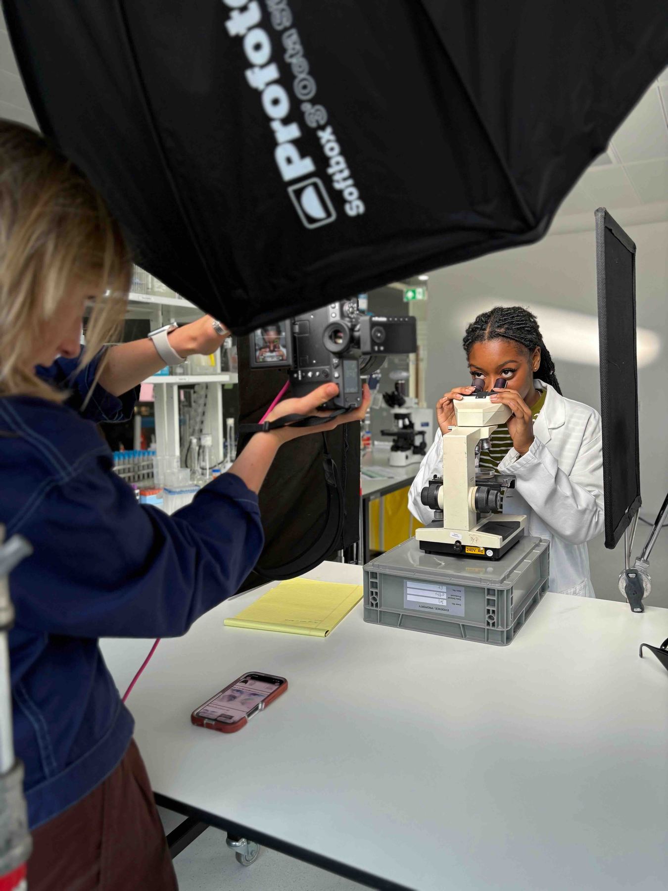 Photographer shooting talent through a microscope setup