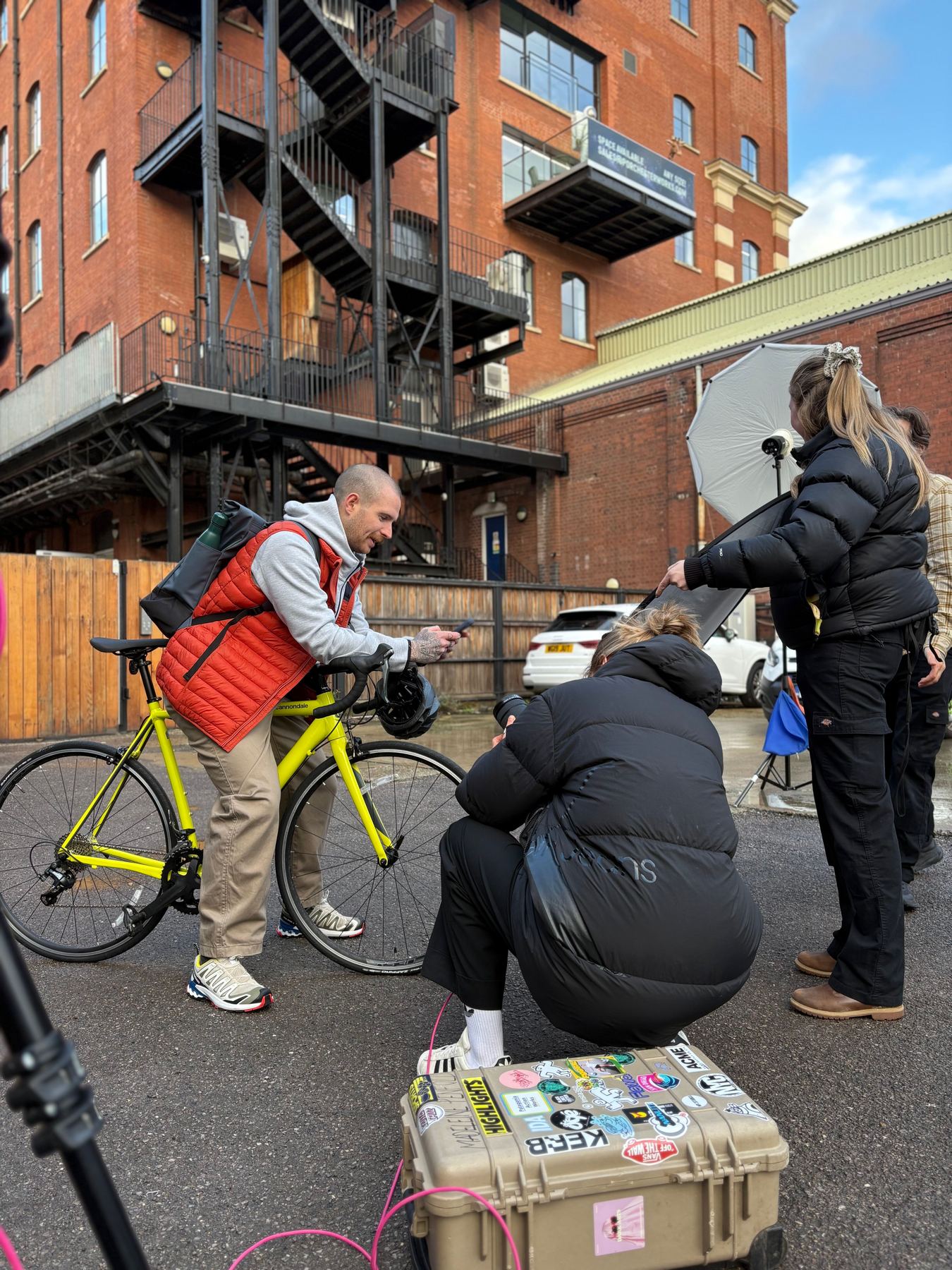 Crew shooting talent with a bicycle on location